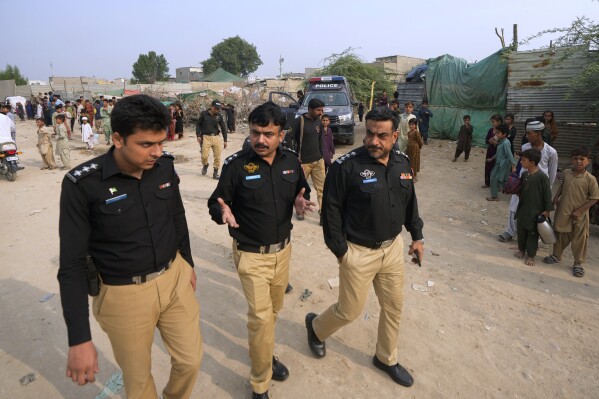 Police officers arrive to conduct a search operation against illegal immigrants, at a neighbourhood of Karachi, Pakistan, Tuesday, Nov. 7, 2023. Pakistan government launched a crackdown on migrants living in the country illegally as a part of the new measure which mainly target all undocumented or unregistered foreigners. (AP Photo/Fareed Khan)