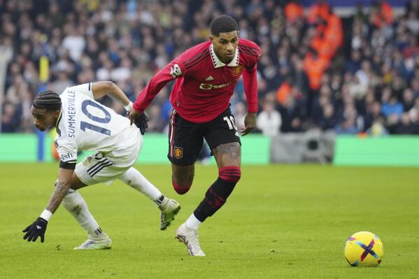 Manchester United's Marcus Rashford, right, challenges for the ball with Leeds United's Crysencio Summerville during the English Premier League soccer match between Leeds United and Manchester United at Elland Road, Leeds, England, Sunday, Feb.12, 2023. (AP Photo/Jon Super)