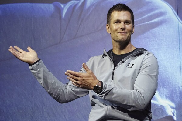 FILE - New England Patriots quarterback Tom Brady gestures during a promotional event, June 22, 2017, in Tokyo. Brady is putting on a Delta Air Lines uniform, at least figuratively. Delta said Wednesday, Sept. 6, 2023, that it has agreed to bring the former star quarterback on board as a long-term strategic adviser. (AP Photo/Eugene Hoshiko, File)