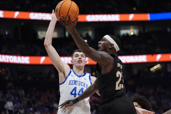 Texas A&M guard Tyrece Radford (23) goes up for a shot as Kentucky forward Zvonimir Ivisic (44) defends during the first half of an NCAA college basketball game at the Southeastern Conference tournament Friday, March 15, 2024, in Nashville, Tenn. (AP Photo/John Bazemore)