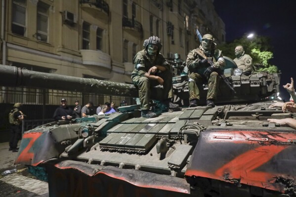 FILE - Members of the Wagner Group military company sit atop of a tank on a street in Rostov-on-Don, Russia, Saturday, June 24, 2023, prior to leaving an area at the headquarters of the Southern Military District. The U.K. says it will declare Russia’s Wagner mercenary group a banned terrorist organization. British officials say the group remains a threat to global security even after the death of leader Yevgeny Prigozhin. . (AP Photo, File)
