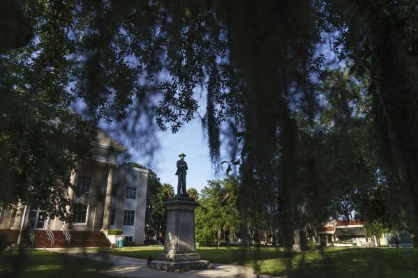 A Confederate statue stands outside the Putnam County Courthouse in Palatka, Fla., Tuesday, April 13, 2021. In the 1920s, Jim Crow Florida was one of the most dangerous places in the South to be Black. (AP Photo/David Goldman)