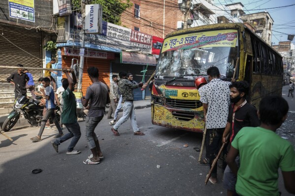 Bangladeshi garment workers vandalize buses during a protest demanding an increase in their wages at Mirpur in Dhaka, Bangladesh, Tuesday, Oct.31, 2023. (AP Photo/Mahmud Hossain Opu)