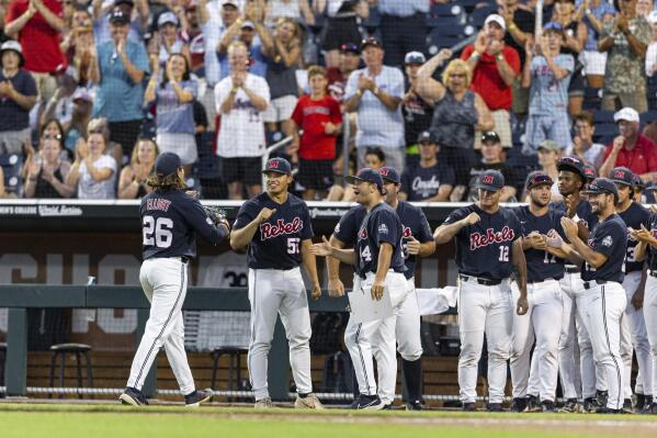 Mississippi pitcher Hunter Elliott (26) walks to his teammates and cheering fans after being relieved in the seventh inning against Arkansas during an NCAA College World Series baseball game, Monday, June 20, 2022, in Omaha, Neb. (AP Photo/John Peterson)