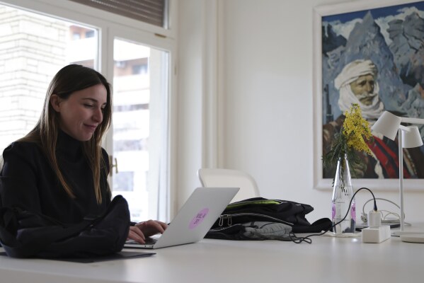 Nita Deda, manager of Art Explora works at her computer at Villa 31 where the late communist dictator Enver Hoxha, once a symbol of totalitarian rule used to live, in Tirana, Albania, Friday, Feb. 7, 2025. (AP Photo/Vlasov Sulaj)