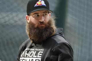 FILE - In this Sept. 11, 2019, file photo, Colorado Rockies right fielder Charlie Blackmon waits to enter the batting cage before the team's baseball game against the St. Louis Cardinals in Denver. All-Star outfielder Charlie Blackmon of the Colorado Rockies has become the first Major League Baseball player known to have tested positive for the coronavirus. A person familiar with Blackmon’s situation confirmed the test result to The Associated Press on condition of anonymity because there was no official announcement. (AP Photo/David Zalubowski, File)