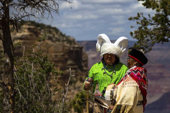 Havasupai tribal members Kris Siyuja, left, and Dianna Sue Uqualla, stand above the Bright Angel Trail in Grand Canyon National Park on Thursday, May 4, 2023. The tribe and the park marked the renaming of a popular campground below the rim from Indian Garden to Havasupai Gardens. (AP Photo/Ty O'Neil)