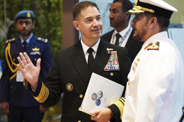 U.S. Navy Vice Adm. Brad Cooper, who heads the Navy's Bahrain-based 5th Fleet, gestures on the sidelines of an event at the International Defense Exhibition and Conference in Abu Dhabi, United Arab Emirates, Tuesday, Feb. 21, 2023. Iranian attacks in the waterways of the Middle East and elsewhere in the region "have the attention of everyone" as tensions rise over Tehran's advancing nuclear program, Cooper said Tuesday. (AP Photo/Jon Gambrell)