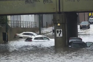 In this image taken from video provided by ABC7 Chicago, several vehicles are stranded in the flooded viaduct at Fifth and Cicero avenues, in Chicago, Sunday, July 2, 2023. (ABC7 Chicago via AP)