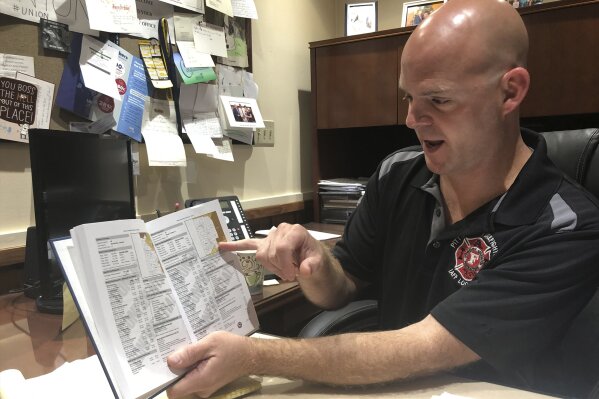 In this Friday, Sept. 20, 2019, photo, Darrin Kelly, president of the AFL-CIO's Allegheny County Labor Council, points out voter registration data while at his office in Pittsburgh, that shows that Democrats across western Pennsylvania have been voting Republican. Kelly is warning national Democrats that the party is moving too far left for many middle-of-the-road Democrats in western Pennsylvania. (AP Photo/Steve Peoples)