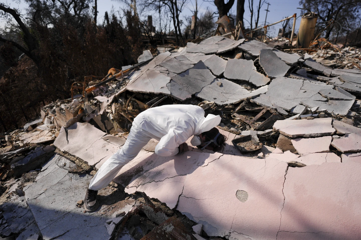 Una pareja inspecciona su hogar devastado tras el incendio Palisades en Los Ángeles.
