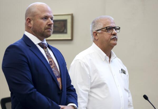 Former Oregon state Rep. Mike Nearman, right, stands with his attorney during a hearing, Tuesday, July 27, 2021, at the Marion County Circuit Court in Salem, Ore. Nearman, who was expelled for letting violent, far-right protesters into the state Capitol pleaded guilty Tuesday to one count of official misconduct. He was sentenced to 18 months probation, during which he will need to complete 80 hours of community service and is banned from the Capitol building and grounds. He will also pay $200 in court fees and $2,700 to the Oregon Legislative Administration for damages done during the Dec. 21 riot. (Abigail Dollins/Statesman-Journal via AP)