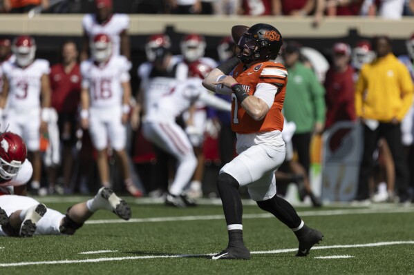 Oklahoma State quarterback Alan Bowman (7) throws a pass in the first half of an NCAA college football game against Arkansas, Saturday, Sept. 7, 2024, in Stillwater, Okla. (AP Photo/Mitch Alcala)