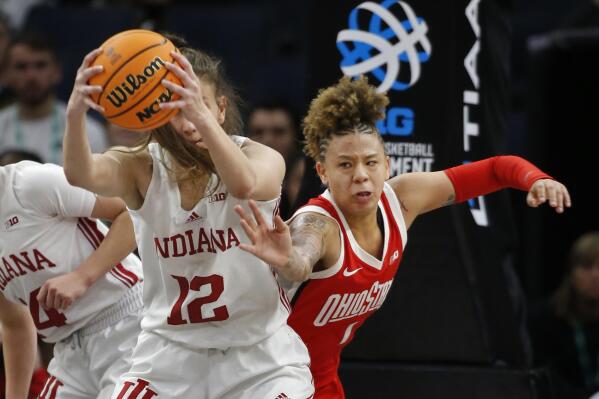 Indiana guard Yarden Garzon (12) holds onto a rebound as Ohio State guard Rikki Harris, right, challenges her for it in the second half of an NCAA college basketball game at the Big Ten women's tournament Saturday, March 4, 2023, in Minneapolis. Indiana won 79-75. (AP Photo/Bruce Kluckhohn)