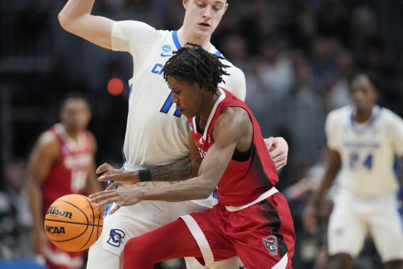 North Carolina State guard Terquavion Smith, front, is fouled by Creighton center Ryan Kalkbrenner in the second half of a first-round college basketball game in the men's NCAA Tournament, Friday, March 17, 2023, in Denver. (AP Photo/David Zalubowski)
