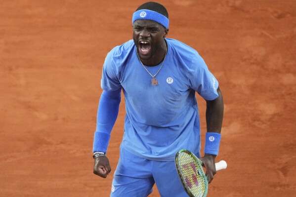 Frances Tiafoe of the U.S. celebrates beating Germany's Daniel Altmaier during their fourth round match of the French Tennis Open, at the Roland-Garros stadium, in Paris, Sunday, June 1 2025. (AP Photo/Lindsey Wasson)