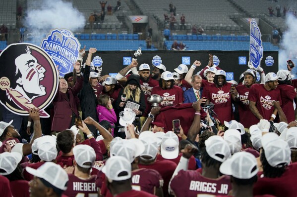 Florida State celebrates after defeating Louisville in the Atlantic Coast Conference championship NCAA college football game Saturday, Dec. 2, 2023, in Charlotte, N.C. (AP Photo/Erik Verduzco)