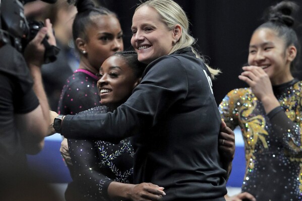 FILE - Simone Biles gets a hug from her coach, Cecile Landi, after competing in the floor exercise in the U.S. Gymnastics Championships, Aug. 27, 2023, in San Jose, Calif. Landi agreed Thursday, April 25, 2024, to become the co-head coach of the women's gymnastics program at Georgia. (Carlos Avila Gonzalez/San Francisco Chronicle via Ǻ, File)