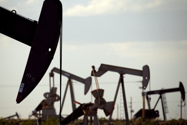 FILE - Pump jacks work in a field near Lovington, N.M., April 24, 2015. The Biden administration is proposing new rules for the nation’s oil and gas leasing program that would raise costs for energy companies to drill on public lands and strengthen requirements for cleaning up old wells where drilling is completed or abandoned. (AP Photo/Charlie Riedel, File)