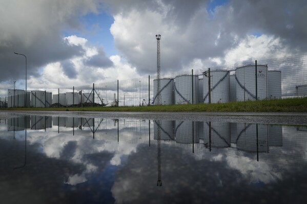 Vesta Terminals holding oil are reflected in Tallinn, Estonia, Wednesday, Oct. 4, 2023. The oil and gas sector, one of the major emitters of planet-warming gases, will need a rapid and substantial overhaul for the world to avoid even worse extremes fueled by human-caused climate change, a report Thursday, Nov. 23, said. (AP Photo/Sergei Grits)