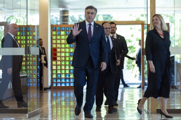 Andrej Plenkovic, centre, arrives at the presidential palace to meet President Zoran Milanovic, in Zagreb, Croatia, Friday, May 10, 2024. Croatian conservative leader and two-time prime minister, Andrej Plenkovic, on Friday was appointed prime minister-designate after he forged an alliance with an extreme party following an inconclusive election. (AP Photo)