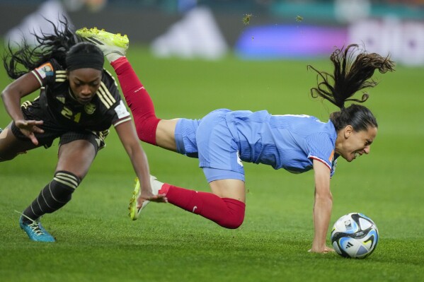 France's Amel Majri, right, vies for the ball with Jamaica's Cheyna Matthews during the Women's World Cup Group F soccer match between France and Jamaica at the Sydney Football Stadium in Sydney, Australia, Sunday, July 23, 2023. (AP Photo/Rick Rycroft)