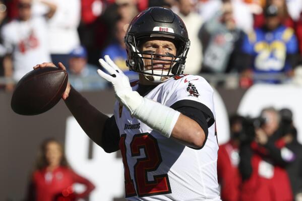 FILE - Tampa Bay Buccaneers quarterback Tom Brady (12) throws a pass against the Los Angeles Rams during the first half of an NFL divisional round playoff football game Jan. 23, 2022, in Tampa, Fla. Brady’s retirement lasted 40 days. He said Sunday, March 13, 2022, he is returning to the Buccaneers for his 23rd season in the NFL. (AP Photo/Mark LoMoglio, File)