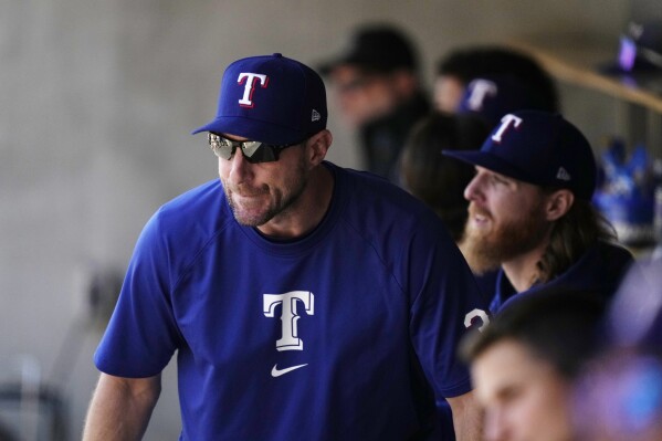 Texas Rangers pitcher Max Scherzer watches from the dugout during the seventh inning of a baseball game against the Detroit Tigers, Tuesday, April 16, 2024, in Detroit. (AP Photo/Carlos Osorio)