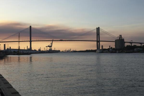 FILE - The Eugene Talmadge Memorial Bridge is pictured at sunset in Savannah, Ga., April 20, 2017. Georgia officials have signed off on a plan to raise Savannah's towering suspension bridge to make room for larger cargo ships calling on the city's busy seaport. (AP Photo/Sally Hale, File)