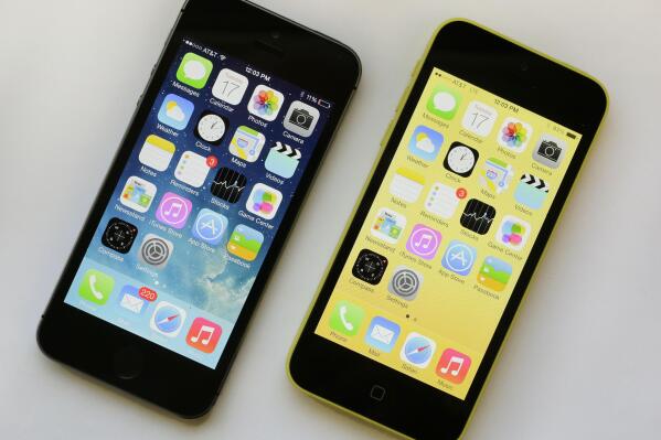 The iPhone 5S, left, and iPhone 5c are displayed, Sept. 17, 2013, in New York. As telecom companies rev up the newest generation of mobile service, called 5G, they’re shutting down old networks — a costly, years-in-the-works process that’s now prompting calls for a delay because a lot of products out there still rely on the old standard, 3G. AT&T in mid-February is the first to shut down the 3G network, which first launched in the U.S. just after the turn of the millennium. AT&T says a delay in retiring the network will hurt its service quality. (AP Photo/Mark Lennihan, file)