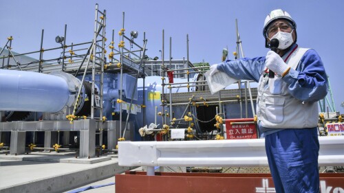 FILE - An employee of Tokyo Electric Power Company explains to the media about the facility to be used to release treated radioactive water at Fukushima Daiichi nuclear power plant in Fukushima, northern Japan, on June 26, 2023. Hong Kong's leader warned Tuesday, July 11, that the city will ban marine products from “a large number prefectures” if Japan discharges treated radioactive wastewater into the sea. (Kyodo News via AP, File)