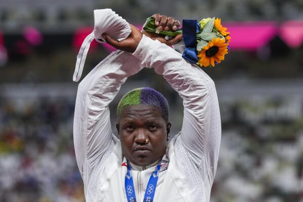 Raven Saunders, of the United States, poses with her silver medal on women's shot put at the 2020 Summer Olympics, Sunday, Aug. 1, 2021, in Tokyo, Japan.  During the photo op at her medals ceremony Sunday night, Saunders stepped off the podium, lifted her arms above her head and formed an “X’ with her wrists. Asked what that meant, she explained: ”It’s the intersection of where all people who are oppressed meet.” (AP Photo/Francisco Seco)