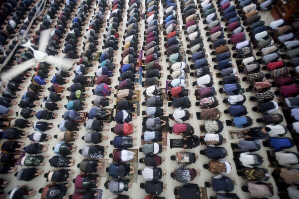 Students perform a prayer during the first day of the holy fasting month of Ramadan at Ar-Raudlatul Hasanah Islamic Boarding School in Medan, North Sumatra, Indonesia, Tuesday, March 12, 2024. (AP Photo/Binsar Bakkara)