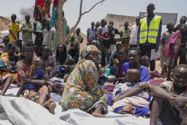 South Sudanese people sit outside a nutrition clinic at a transit center in Renk, South Sudan, on May 16, 2023. (AP Photo/Sam Mednick, File)