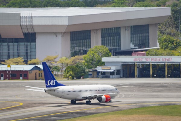 A Scandinavian Airlines medevac plane arrives at Langkawi, where the Norwegian king is being treated for an infection, in Malaysia, Friday, March 1, 2024. King Harald V, Europe's oldest monarch at 87, was hospitalized after he fell ill during a vacation, the royal palace in Oslo announced Tuesday. (AP Photo/Vincent Thian)