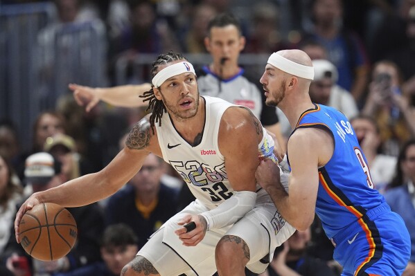 Denver Nuggets forward Aaron Gordon, left, looks to pass the ball as Oklahoma City Thunder guard Alex Caruso defends in the second half of Game 6 in the Western Conference semifinals of the NBA basketball playoffs Thursday, May 15, 2025, in Denver. (AP Photo/David Zalubowski)