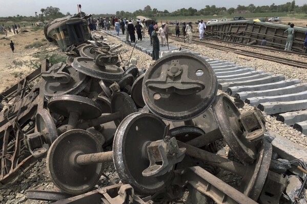 Workers repair a railway track at the site of Sunday's train derailed incident, near Nawabshah, a district of Pakistan's southern Sindh province, Monday, Aug. 7, 2023. Ten cars of a passenger train derailed in southern Pakistan on Sunday, killing at least 30 people and injuring more than 90 others, officials said. (AP Photo/Muhammad Osama)