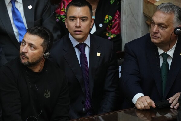 Hungary's Prime Minister Viktor Orban, right, and Ukraine's President Volodymyr Zelenskyy, left, attend the inauguration of Argentina's new President Javier Milei at Congress in Buenos Aires, Argentina, Sunday, Dec. 10, 2023. At center is unidentified. (AP Photo/Natacha Pisarenko)