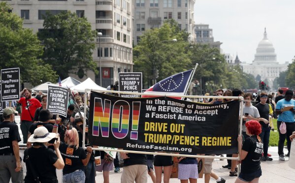 
              Groups protest in Freedom Plaza with the U.S. Capitol in the background, on the one year anniversary of Charlottesville's "Unite the Right" rally, Sunday, Aug. 12, 2018, in Washington. (AP Photo/Alex Brandon)
            