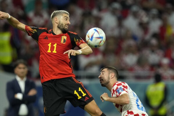 FILE - Belgium's Yannick Carrasco, left, vies for the ball with Croatia's Josip Juranovic during the World Cup group F soccer match between Croatia and Belgium at the Ahmad Bin Ali Stadium in Al Rayyan, Qatar, on Dec. 1, 2022. Belgium midfielder Yannick Carrasco brushed off criticism of human rights Thursday following his transfer to Al-Shabab FC from Atletico Madrid. Carrasco, who trains this week with the Belgian squad ahead of a couple of European Championship qualifiers, asked the national team's staff to organize a press conference so he could explain the reasons behind his move. (AP Photo/Francisco Seco)