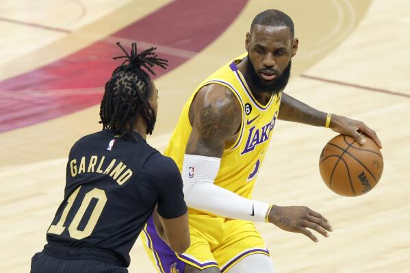 Los Angeles Lakers forward LeBron James is defended by Cleveland Cavaliers guard Darius Garland (10) during the first half of an NBA basketball game Tuesday, Dec. 6, 2022, in Cleveland. (AP Photo/Ron Schwane)