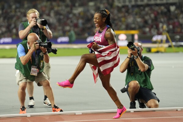 Sha'Carri Richardson, of the United States, celebrates winning the women's 100 meters during the World Athletics Championships in Budapest, Hungary, Monday, Aug. 21, 2023. (AP Photo/Ashley Landis)