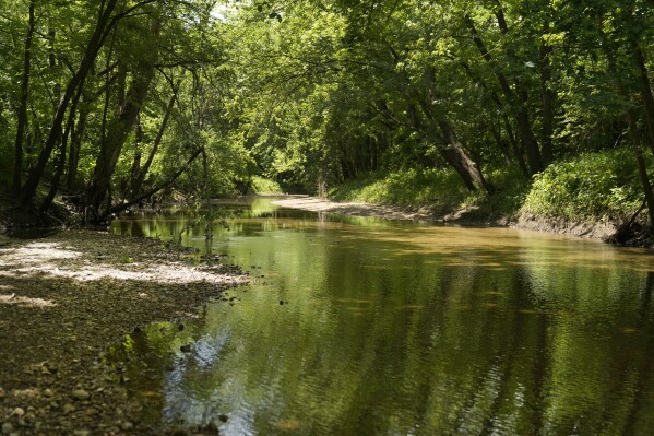 Bear Creek flows Wednesday, May 22, 2024, in Hannibal, Mo. The creek, which runs from the mouth of the Mississippi through the south end of town, has been a consistent source of flooding over the years. (AP Photo/Jeff Roberson)