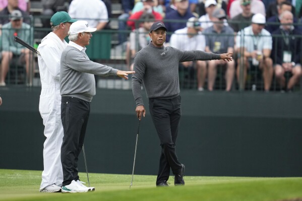 Tiger Woods, right, talks with Fred Couples on the fourth hole during a practice round in preparation for the Masters golf tournament at Augusta National Golf Club Tuesday, April 9, 2024, in Augusta, Ga. (AP Photo/Ashley Landis)