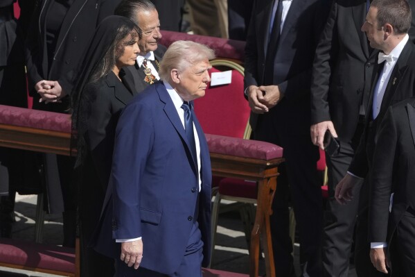 President Donald Trump and first lady Melania Trump arrive for the funeral of Pope Francis in St. Peter's Square at the Vatican, Saturday, April 26, 2025. (AP Photo/Markus Schreiber)