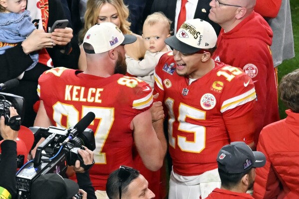 Kansas City Chiefs quarterback Patrick Mahomes (15) and tight end Travis Kelce (87) celebrate their win against the San Francisco 49ers in overtime during the NFL Super Bowl 58 football game Sunday, Feb. 11, 2024, in Las Vegas. The Chiefs won 25-22. (AP Photo/David Becker)