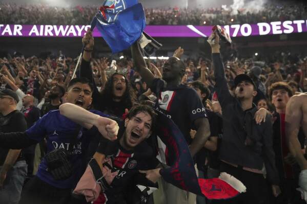 PSG supporters celebrate during the Champions League final soccer match between Paris Saint-Germain and Inter Milan, Saturday, May 31, 2025 at the Parc des Princes stadium in Paris. (AP Photo/Michel Euler)