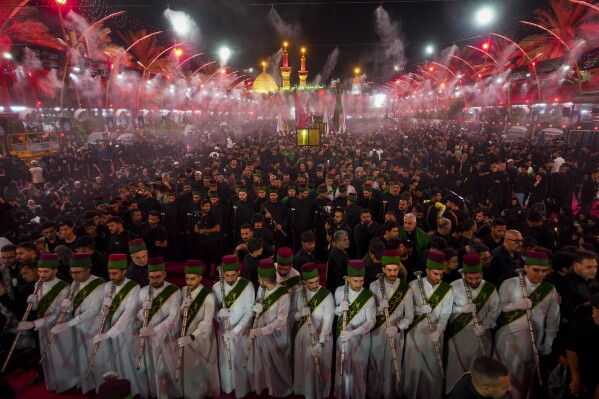 FILE - Shiites participate in the Ashoura procession on the 9th day of Muharram in Karbala, Iraq, Friday, July 28, 2023. In the Middle East and North Africa, where religion is often ingrained in daily life's very fabric, rejecting faith can come with social or other repercussions, so many of the "nones," a group that includes agnostics, atheists and "nothing in particular" conceal that part of themselves, as blasphemy laws and policies are widespread in the region. (AP Photo/Anmar Khalil, File)