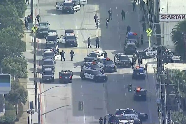 In this screengrab made from video provided by ABC7 Los Angeles, law enforcement gathers outside Spartan College of Aeronautics and Technology in Inglewood, Calif., Friday, May 2, 2025, after two women were shot on the campus. (ABC7 Los Angeles via AP)