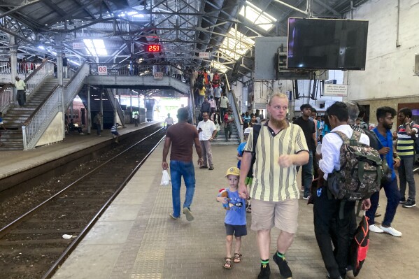 Commuters walk on a platform at the Fort railway station during a trade union strike by locomotive drivers in Colombo, Sri Lanka, Wednesday, Sept. 13, 2023. (AP Photo/Eranga Jayawardena)